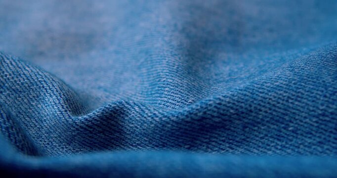 Close-up video of rumpled denim fabric.Abstract background.