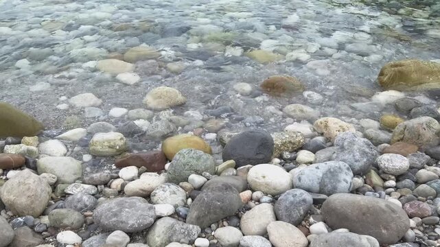 sea surf on pebble beach, close-up, slow motion
