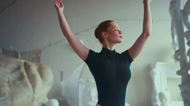 Professional self-confident ballerina rehearsing in theatre or dance school. Medium portrait of beautiful woman performing choreographic movements by hands, tender and graceful female dancer in class