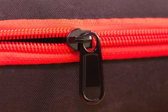 The red zipper on the bag.