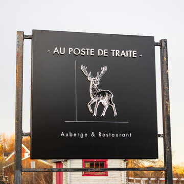 Sainte-Famille, Qu&eacute;bec, Canada, May 13, 2026 - Au Poste de Traite sign for the inn and restaurant located on the Island of Orleans at 2287 Chemin Royal