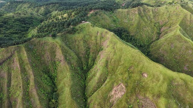 Cinematic Drone Tilt Up Revealing Qarraba Peninsula at Ghajn Tuffieha Bay, Malta from the seaside showing inland 