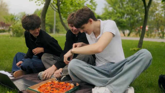 Three Teen Friends Gesturing and Laughing During Group Study Session