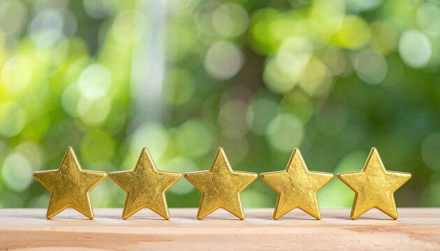Five glowing golden stars on wooden table, green background, premium service and excellence symbolism, top rating, best quality.