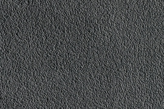 Dark textured surface showing small raised bumps