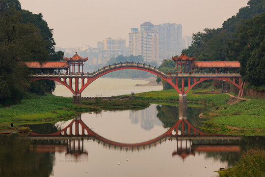 Traditional red chinese arch Haotu bridge reflecting in river