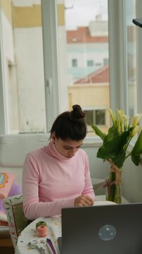 Skillful woman coordinates online craft shipments with labels effectively