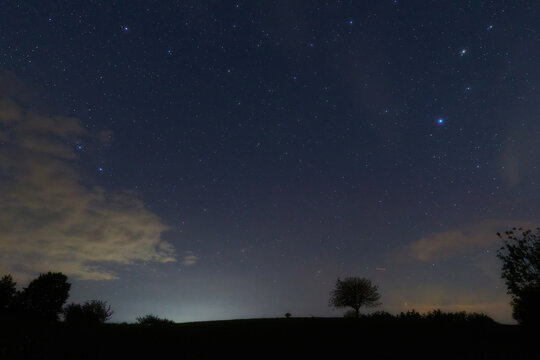 Constellations, landscape, Milky Way stars on a dark countryside skies.