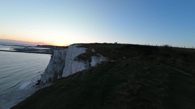 Aerial view flying along the white cliffs of dover at sunset