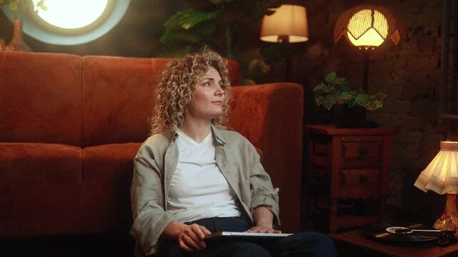 Disappointed curly haired woman closing laptop with sadness after unsuccessful remote work at home. High quality 4k footage
