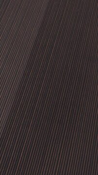 Moody minimalist plowed field lines with abstract earthy patterns in rural landscape, Vertical 9x16 format, Aerial top down lateral flight, 4K