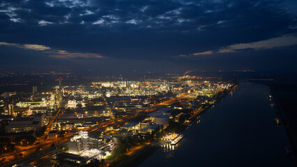 Fototapeta premium Night aerial view of industrial complex along river