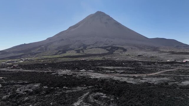 Aerial shot of the symmetrical Pico do Fogo volcanic cone rising from the black ash plains of Ch&atilde; das Caldeiras, Cabo Verde. Iconic geological landmark of the Atlantic island