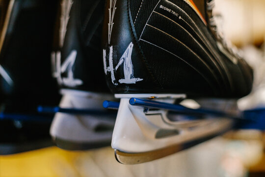 Close-up of a black ice hockey skate heel with the number 41 written on it, stored on a rental rack.