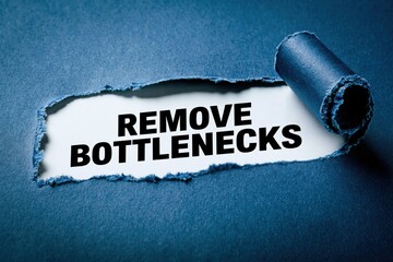 Fototapeta premium Remove Bottlenecks productivity advice on torn paper