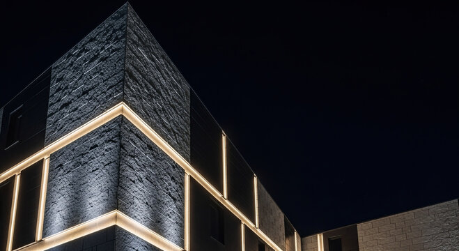 Modern architectural facade with glowing LED light lines and stone texture at night.