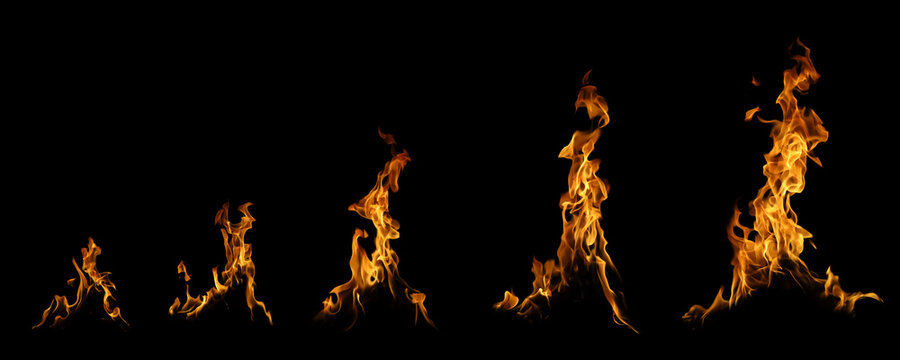Collection of real fire flames and bonfire sparks isolated on black background. Set of different stages of burning fire blaze for graphic design, heat energy concept and hot atmosphere element.
