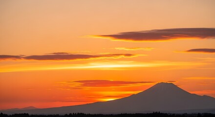Fototapeta premium Breathtaking sunset view with the iconic silhouette of mount fuji against a vibrant orange and golden sky in japan