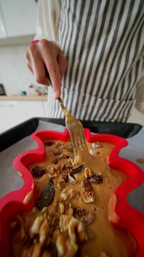 Pressing nuts and batter with fork for detailed texture