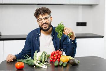 Fototapeta premium Man preparing healthy meal with fresh vegetables