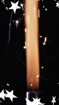 Vertical video: Sparkler igniting on purple tube, flame rising with sparks, stars drifting for demo