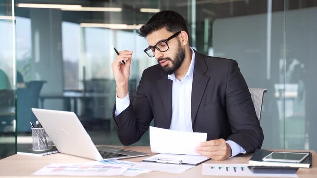 Overworked businessman is tired of doing paperwork and tasks on computer sitting at workplace at desk in business office. Exhausted worker in formal suit overtired, burnout, deadline. Overload at work