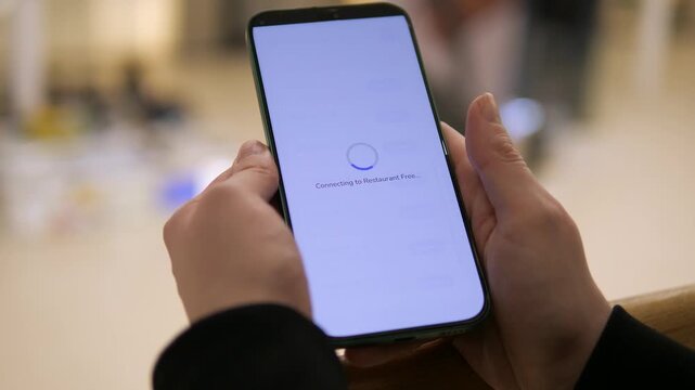 Browsing available WiFi networks on a smartphone. The user selects an open network and taps connect to gain internet access. Perfect for illustrating public WiFi, connectivity, and network management.