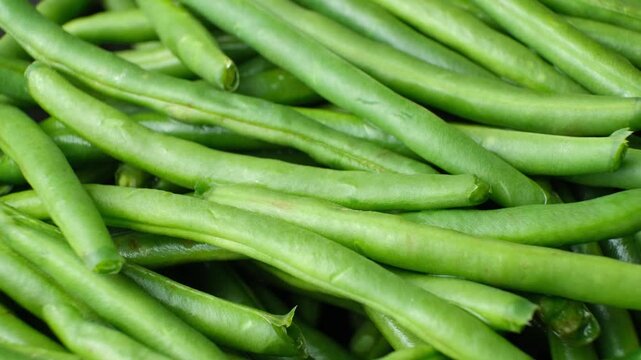 Raw organic green beans slow rotating