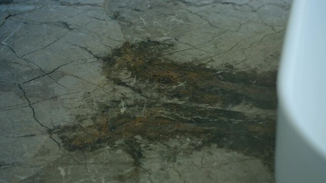 Close view shows marble surface with natural veins and brown patch in center, texture looks rough yet elegant, colors blend softly creating calm and organic feel