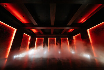 Fototapeta premium A dark, smoky interior with illuminated red columns creates a dramatic and mysterious atmosphere.