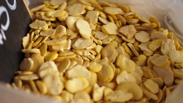 Display of dried fava beans at a traditional Italian market, a classic ingredient in many regional dishes.