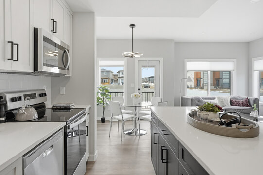 Modern kitchen with sleek white countertops and dark cabinets