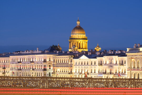 Architectural night photography of Saint Petersburg with the iconic Isaakievsky Cathedral dome dominating the skyline above the Admiralty embankment