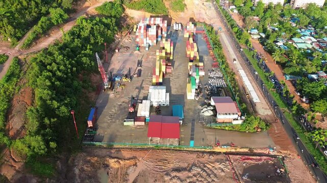 Dynamic overhead view showcasing expansive intermodal cargo terminal with intense shipping activity
