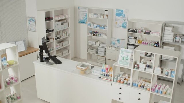 Wide angle shot of empty pharmacy interior with focus on checkout counter in clean while color, CCTV footage view, no people, copy space