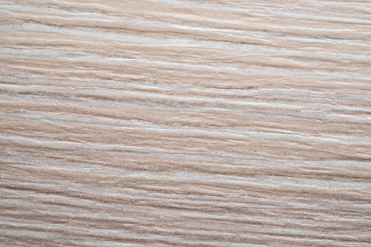 Macro texture of artificial wood grain furniture facade material. Decorative synthetic surface for interior design.