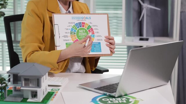 A businesswoman presented an ESG report, showcasing ESG (Environment, Social, Governance) investment concepts. Women used computers to analyze clean energy.