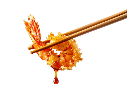 Crispy golden tempura shrimp with savory dripping sauce held by wooden chopsticks.