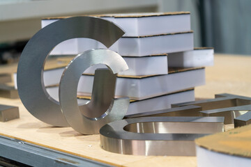 Close Up Stainless Steel Channel Letter Fabrication in Sign Workshop