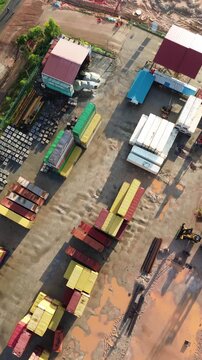 Vast aerial overview of a busy intermodal freight depot with diverse container arrays