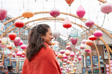 Woman smiling while exploring an illuminated street in Guilin China © Juan