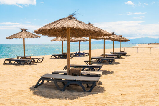 Sun loungers and beach umbrellas at the coastline in Le Barcar&egrave;s - France