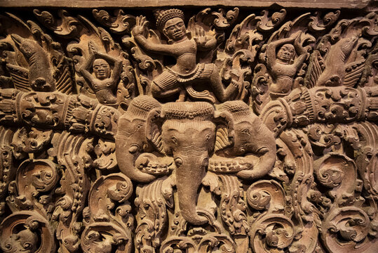 Intricate ancient Champa Kingdom sandstone relief featuring Hindu mythological figures and elephants, exhibited at the Museum of Cham Sculpture in Da Nang, Vietnam
