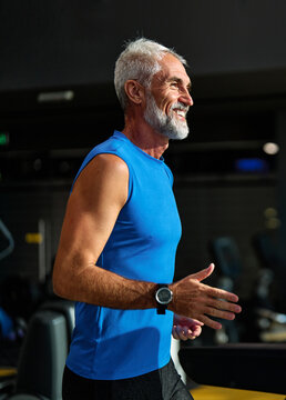 Portrait of a senior man exercising in a gym, mature couple running using threadmill machine equipment, healthy lifestyle and cardio exercise at fitness club concepts, vitality and active senior, coac