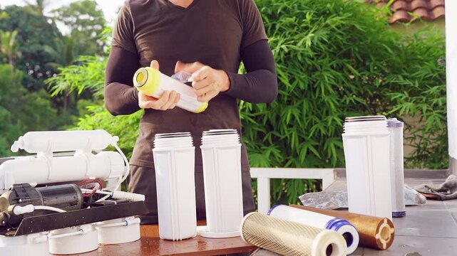 Close Up Installation of Mineral Water Filter Cartridge Into Reverse Osmosis Purification System Outdoors, Clean Water Technology and Home Service