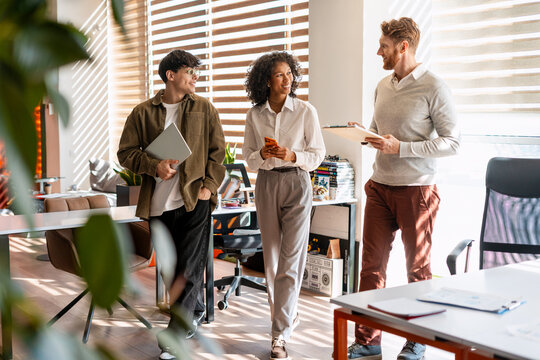 Diverse business team collaborating in shared modern office