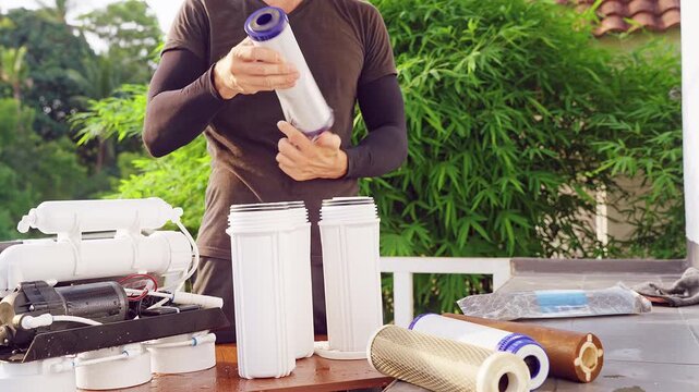 Close Up Unpacking New Water Filter Cartridge for Reverse Osmosis Purification System Outdoors, Clean Water Technology and Household Maintenance