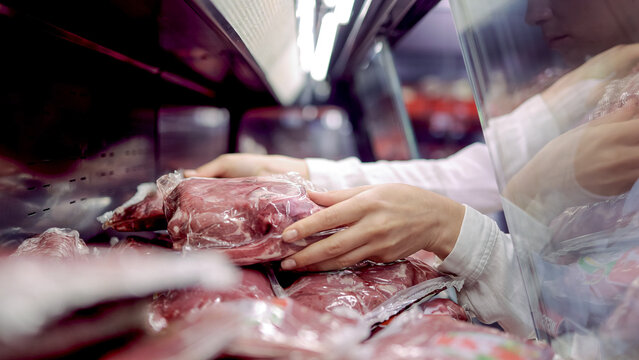 Close-up of fresh meat cuts displayed on supermarket shelf. Concept grocery retail, food quality and butchery products.
