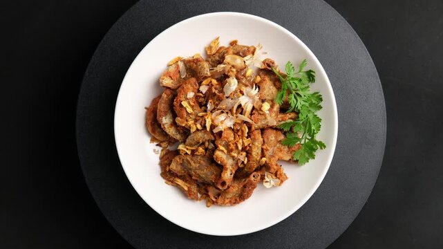 Deep Fried Pork Intestines with Crispy Garlic in white plate.