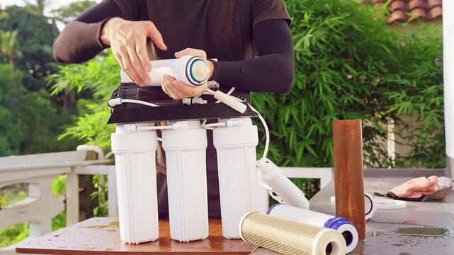 Close Up Removal of Old Reverse Osmosis Membrane Filter From Water Purification System Outdoors, Dirty Filtration Maintenance and Clean Water Service
